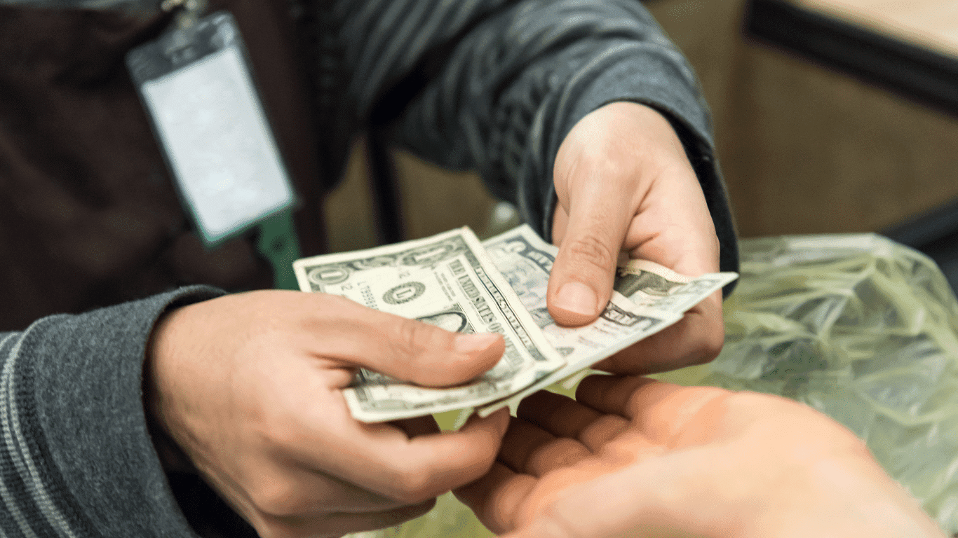 Cash being handed over at a counter